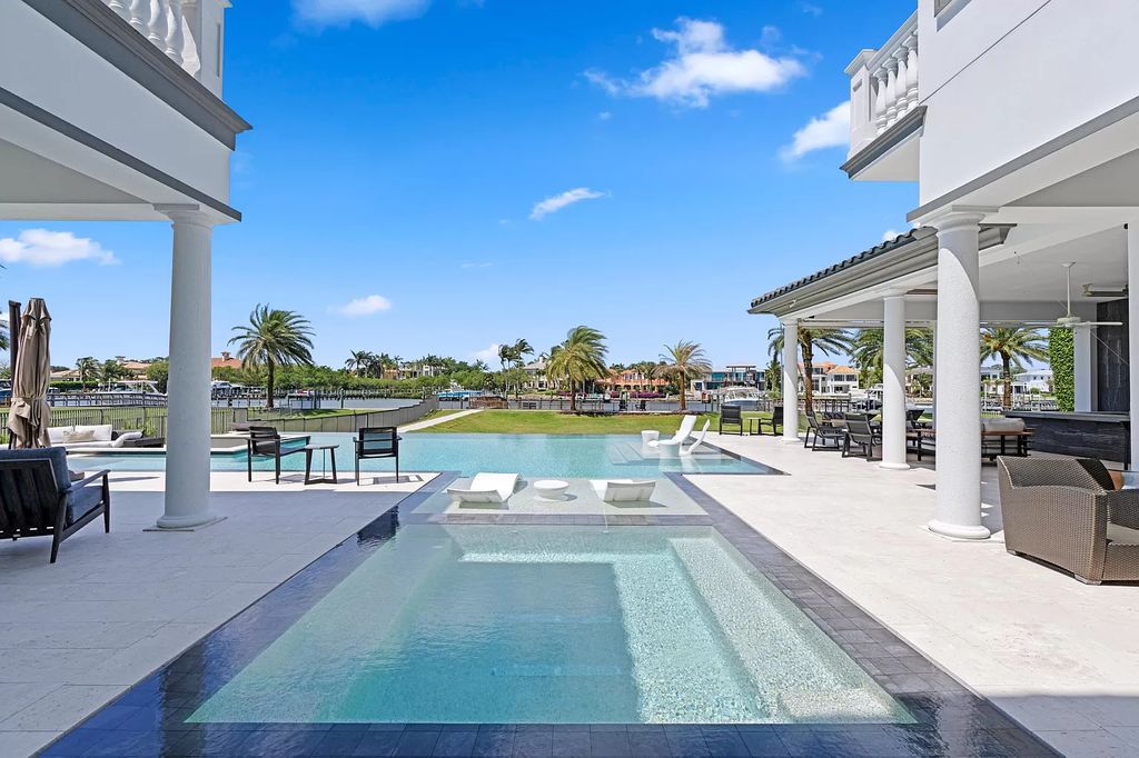 Discover unparalleled luxury living at 13815 Baycliff Drive, North Palm Beach! This custom-built waterfront oasis in the esteemed Frenchman's Harbor community offers over 100 feet of direct intracoastal frontage with a private dock for up to a 70-foot boat, plus a new 4-jet ski lift and platform.