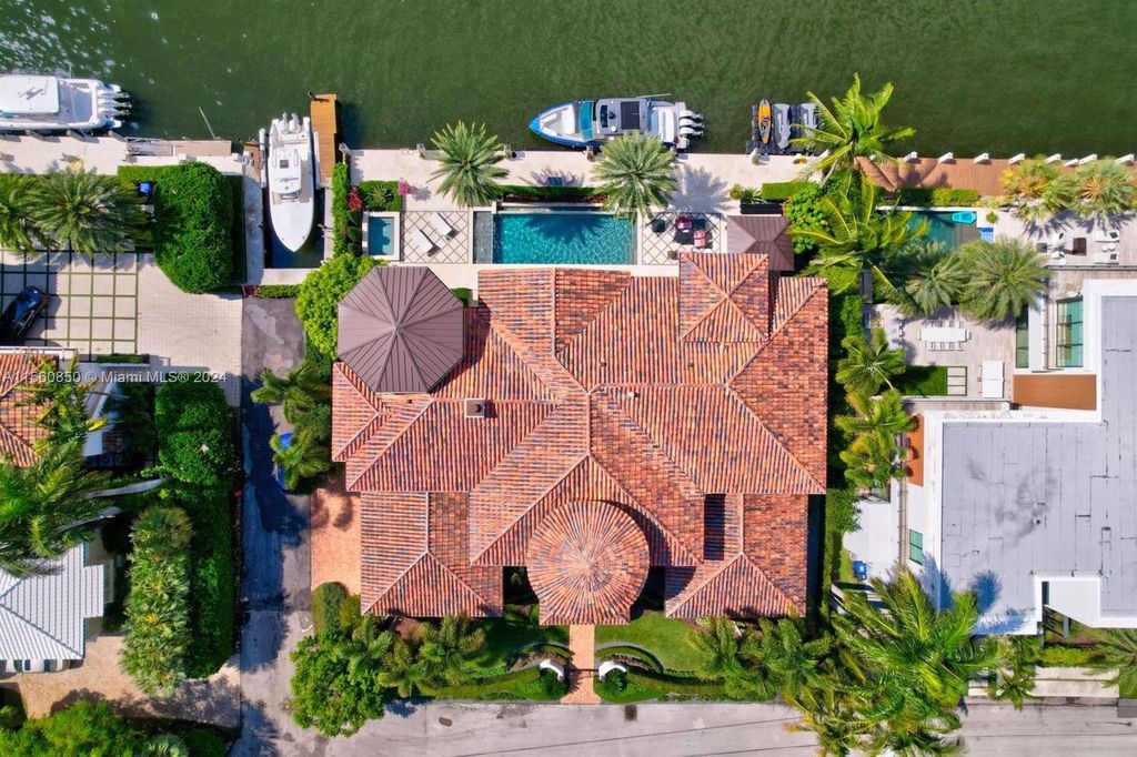 Indulge in the epitome of luxury waterfront living at 821 Solar Isle Dr, Fort Lauderdale, FL 33301. This stunning custom modern Santa Barbara inspired Estate offers rare 120 feet of protected deep water, capturing breathtaking open Intracoastal views.