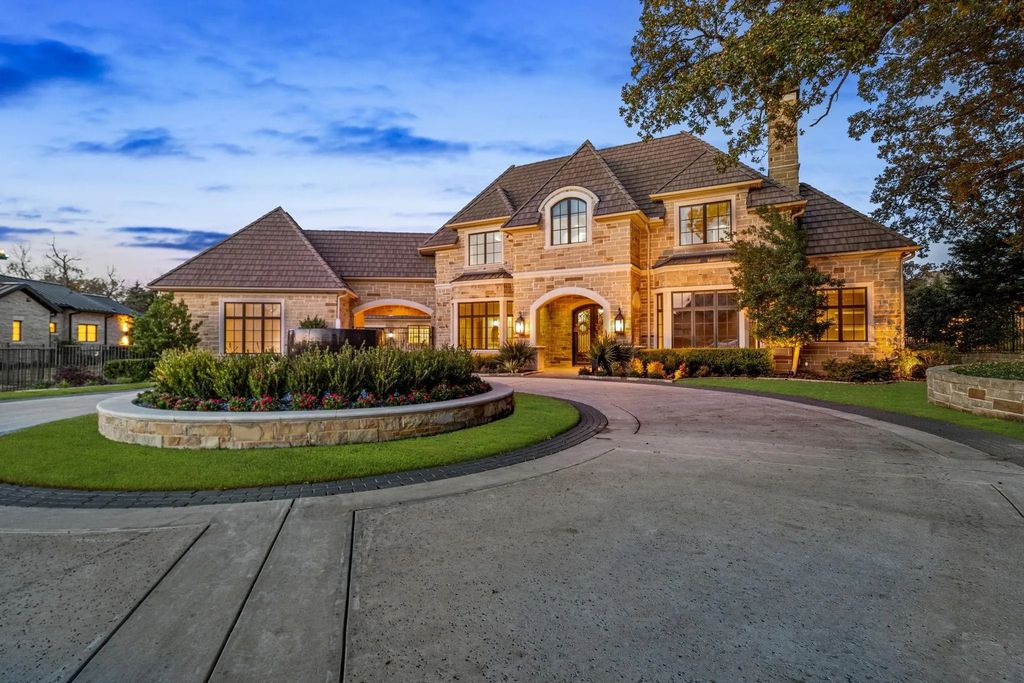 1702 Carlyle Court Home in Westlake, Texas. Discover the allure of this stunning Calais Custom home situated on a rare 1.5-acre lot in Westlake. Featuring grand foyer, gourmet kitchen, glass-encased wine cellar, game room with wet bar, and luxurious master suite with outdoor access.