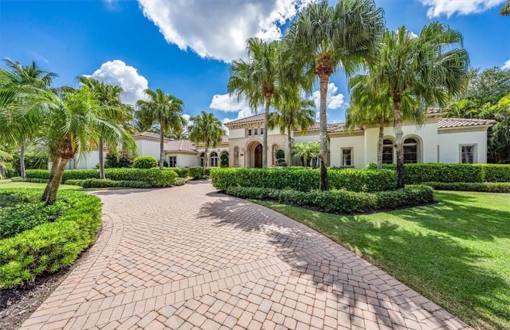 Discover an exquisite 6,500 sq ft single-level home at 2116 Canna Way, Naples, FL, set on a stunning 0.78-acre lot with picturesque lake and golf course views.