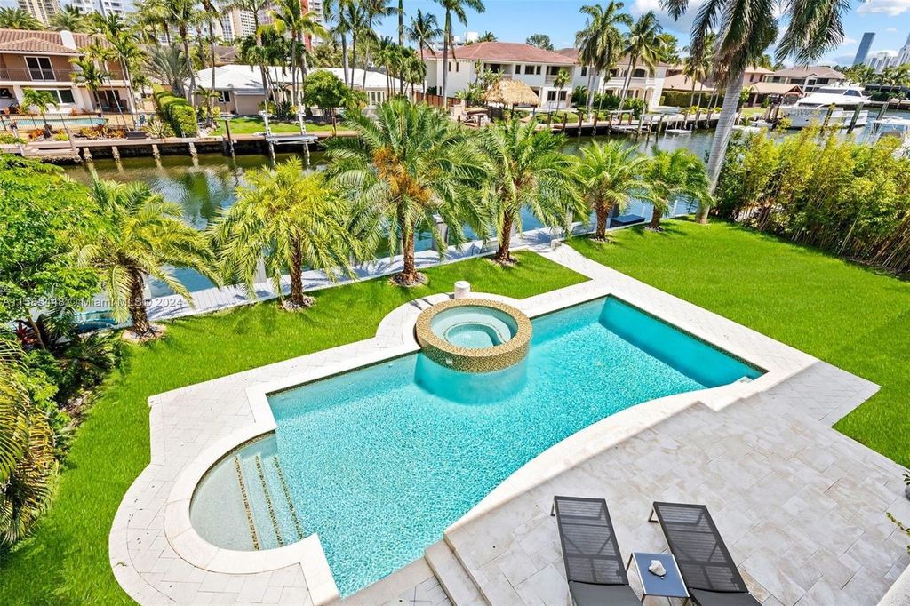 Located in the prestigious gated community of Golden Isles, this exquisite waterfront home at 631 Hibiscus Dr, Hallandale Beach, boasts six bedrooms and seven and a half opulent bathrooms within its 5,829 square feet of refined living space