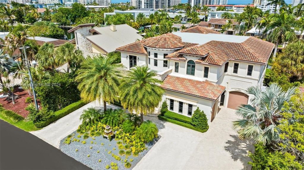 Located in the prestigious gated community of Golden Isles, this exquisite waterfront home at 631 Hibiscus Dr, Hallandale Beach, boasts six bedrooms and seven and a half opulent bathrooms within its 5,829 square feet of refined living space