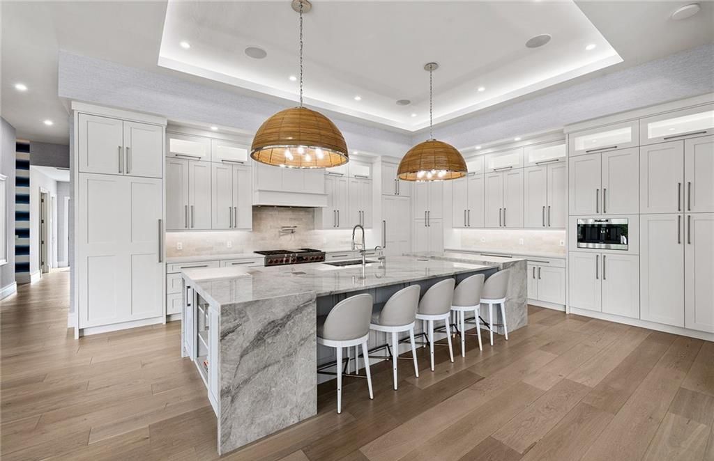 Experience the epitome of luxury living in this timeless yet contemporary Pine Ridge residence, where superior craftsmanship and sustainable design converge on a sprawling 1.72-acre corner lot.