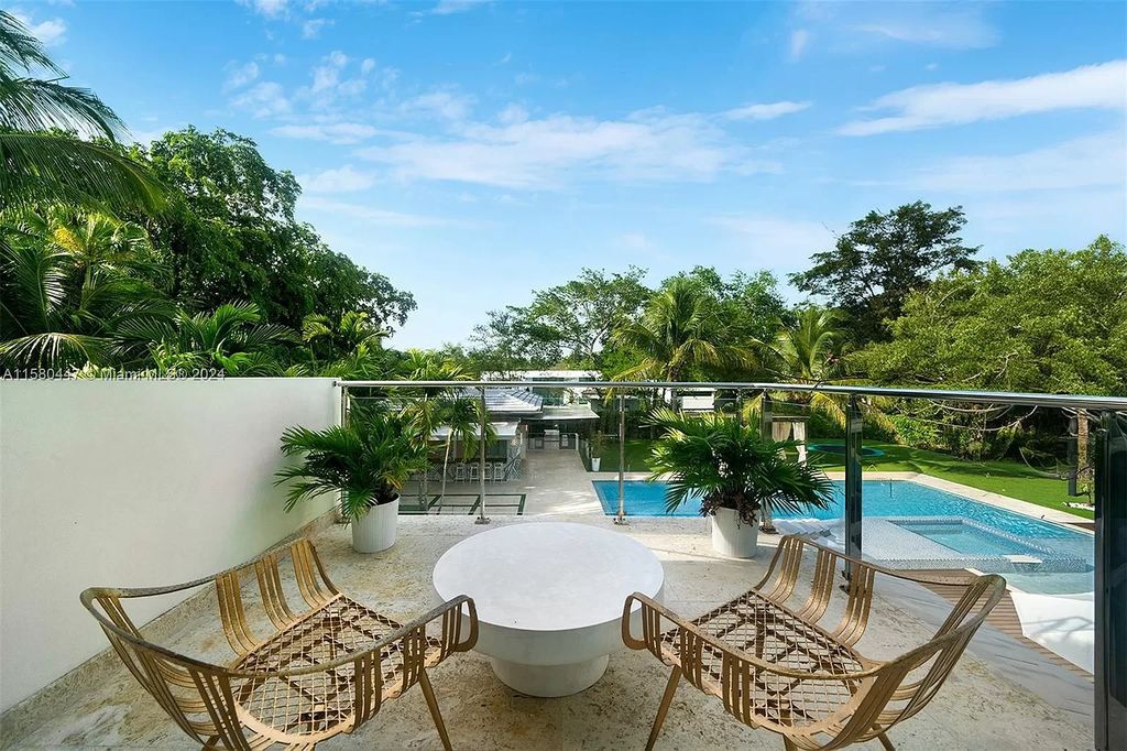 Welcome to 6831 SW 106th St, Pinecrest, Florida 33156 – an exquisite gated 2-story modern sanctuary. This luxurious 6-bed, 9-bath home spans 8,540 sq ft on a 0.87-acre lot, featuring elegant formal living and dining areas, a spacious gourmet chef's kitchen, and an elevator to four suite bedrooms, including a lavish master suite with dual sinks, a spa whirlpool, two walk-in closets, and balcony access.