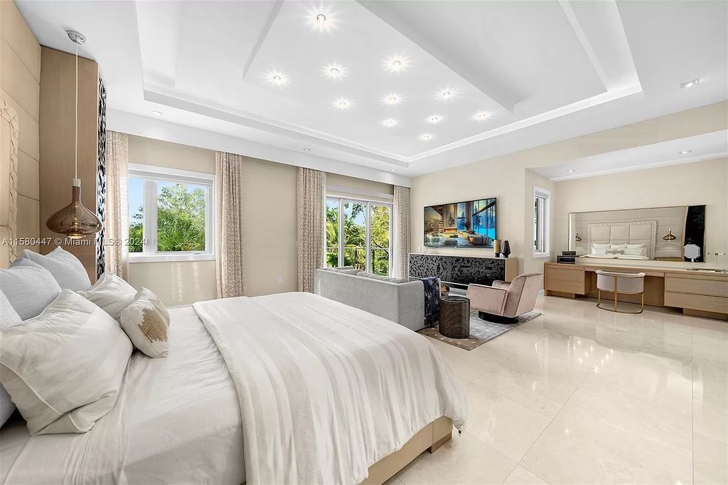 Welcome to 6831 SW 106th St, Pinecrest, Florida 33156 – an exquisite gated 2-story modern sanctuary. This luxurious 6-bed, 9-bath home spans 8,540 sq ft on a 0.87-acre lot, featuring elegant formal living and dining areas, a spacious gourmet chef's kitchen, and an elevator to four suite bedrooms, including a lavish master suite with dual sinks, a spa whirlpool, two walk-in closets, and balcony access.