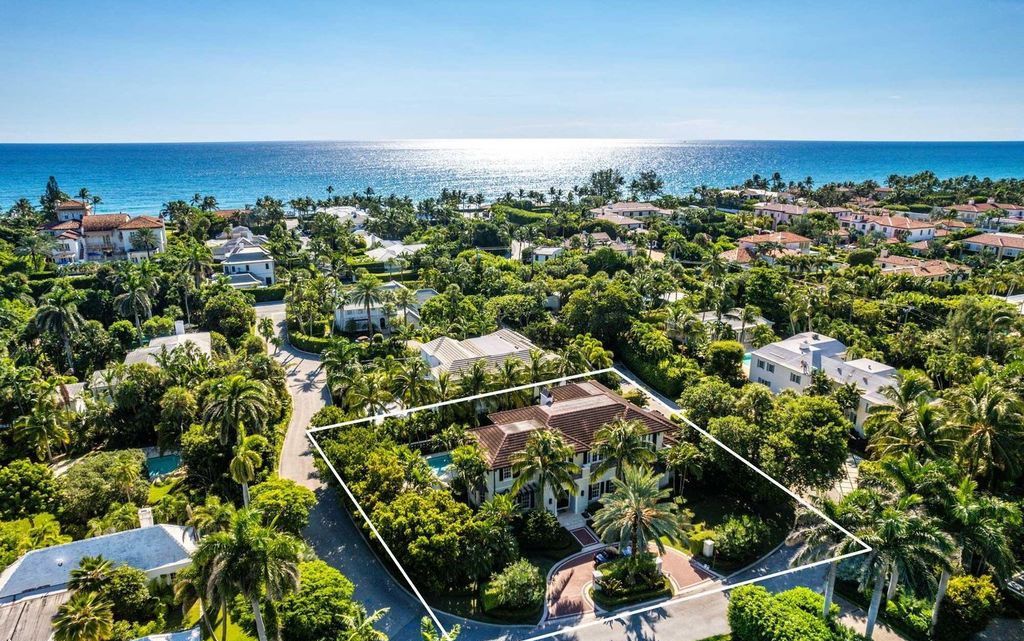 Discover refined living in Palm Beach's prestigious Estate Section at 13 Via Vizcaya. This like-new home on a rare, nearly half-acre lot boasts stunning water views and a private cul-de-sac setting.