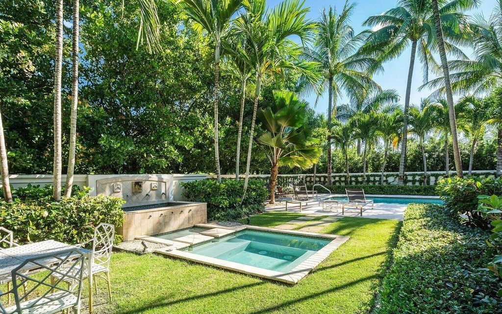 Discover refined living in Palm Beach's prestigious Estate Section at 13 Via Vizcaya. This like-new home on a rare, nearly half-acre lot boasts stunning water views and a private cul-de-sac setting.