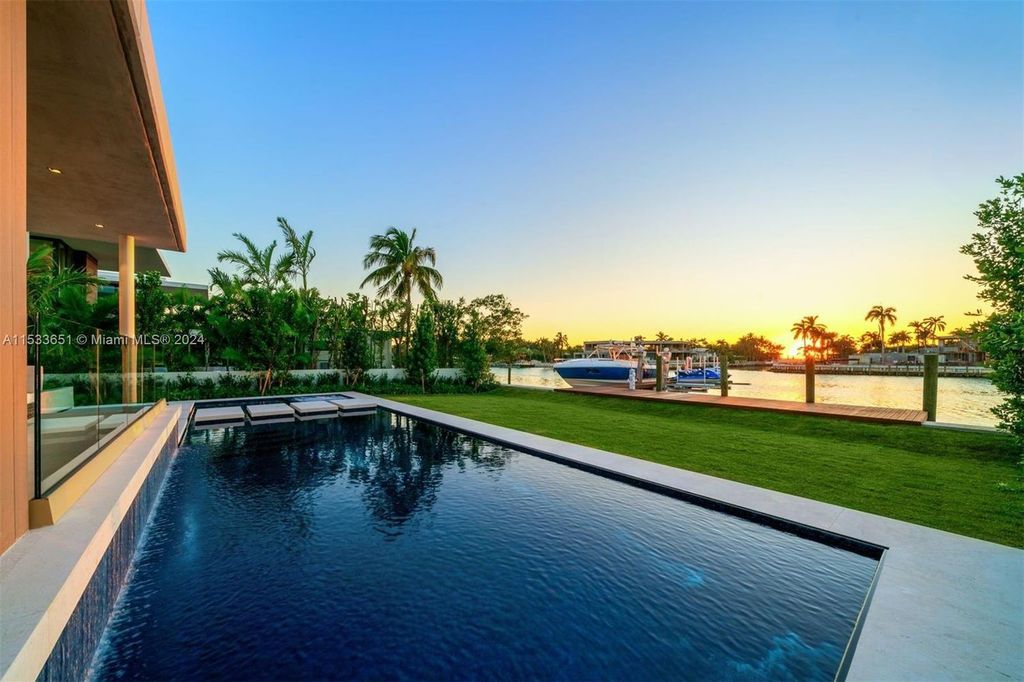 Discover refined living at 6494 Allison Rd, Miami Beach - a turnkey gated western waterfront island residence featuring 6 beds, 9 baths, and 7,719 square feet of luxury.
