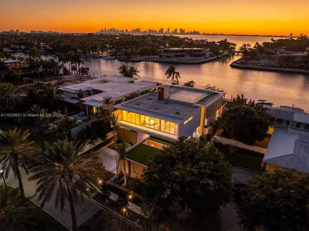 Discover refined living at 6494 Allison Rd, Miami Beach - a turnkey gated western waterfront island residence featuring 6 beds, 9 baths, and 7,719 square feet of luxury.