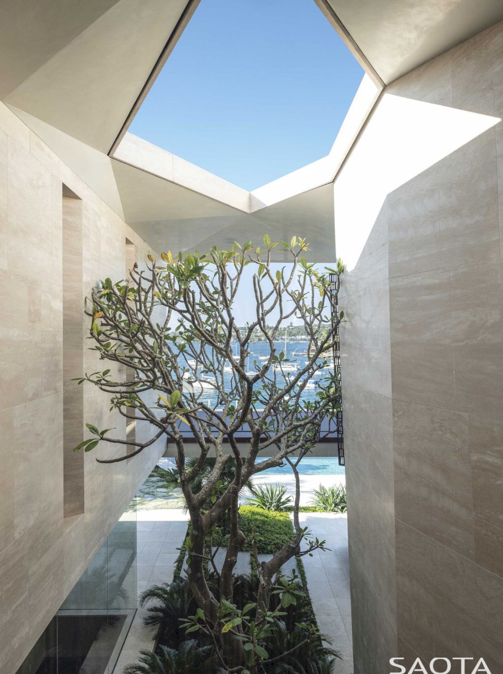 Water's Edge with Stone Covers Exterior & Interior by SAOTA