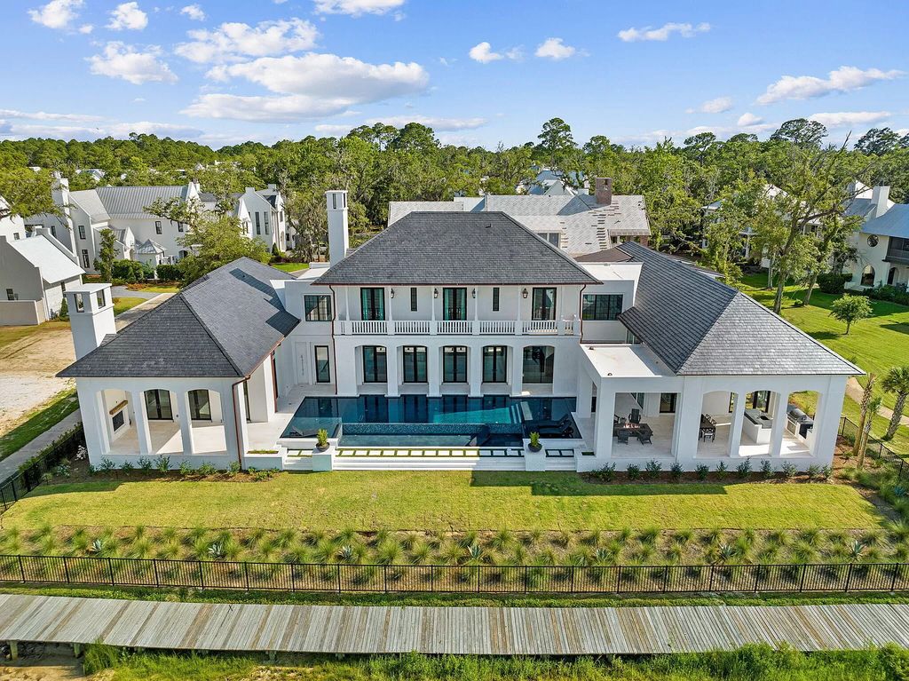 Nestled on a double homesite with 150'+ of Choctawhatchee Bay frontage in the prestigious gated enclave of Churchill Oaks, 51 Junop Court is a stunning legacy residence designed by Matt Savois and built by Grand Bay Construction.
