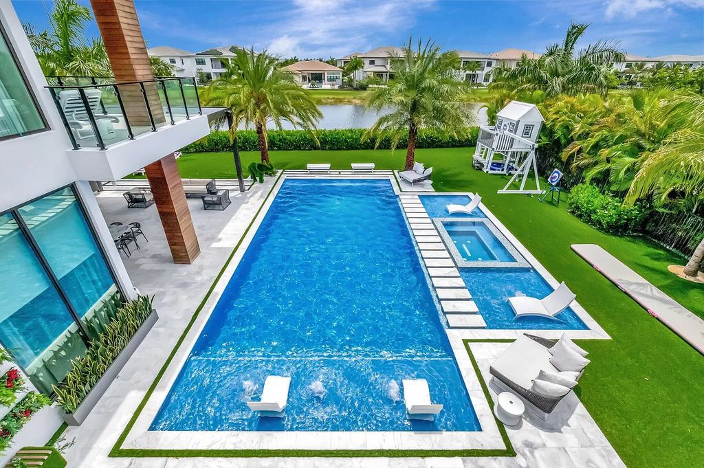 Welcome to this lavish modern luxury estate in the prestigious Boca Bridges. This distinguished "Dali" contemporary masterpiece, one of only seven, spans 8,000 square feet on a large waterfront lot.