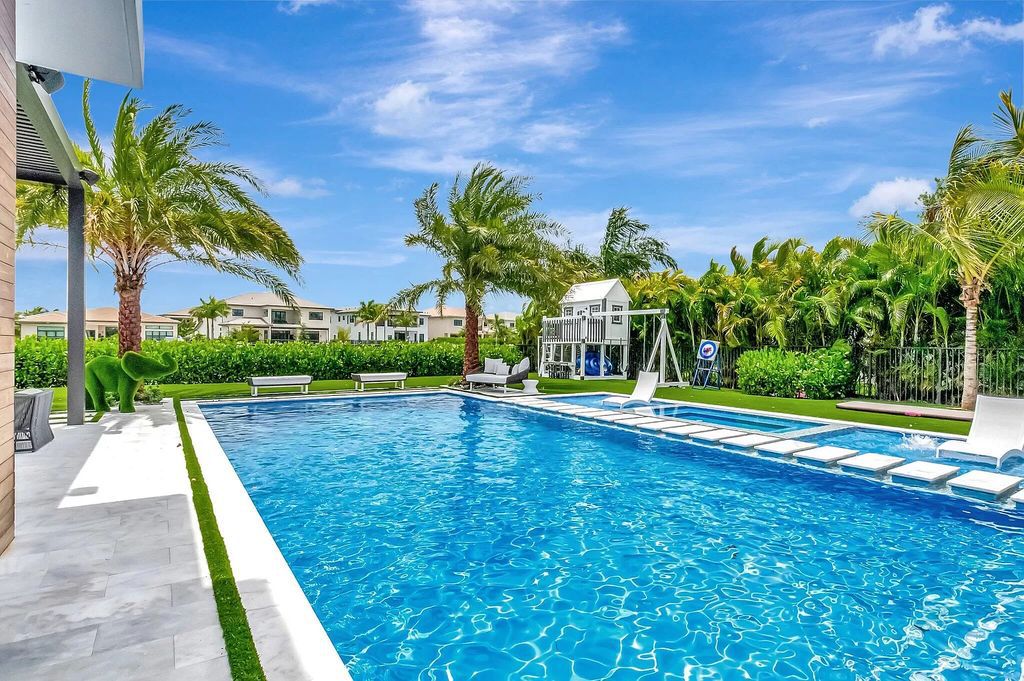 Welcome to this lavish modern luxury estate in the prestigious Boca Bridges. This distinguished "Dali" contemporary masterpiece, one of only seven, spans 8,000 square feet on a large waterfront lot.