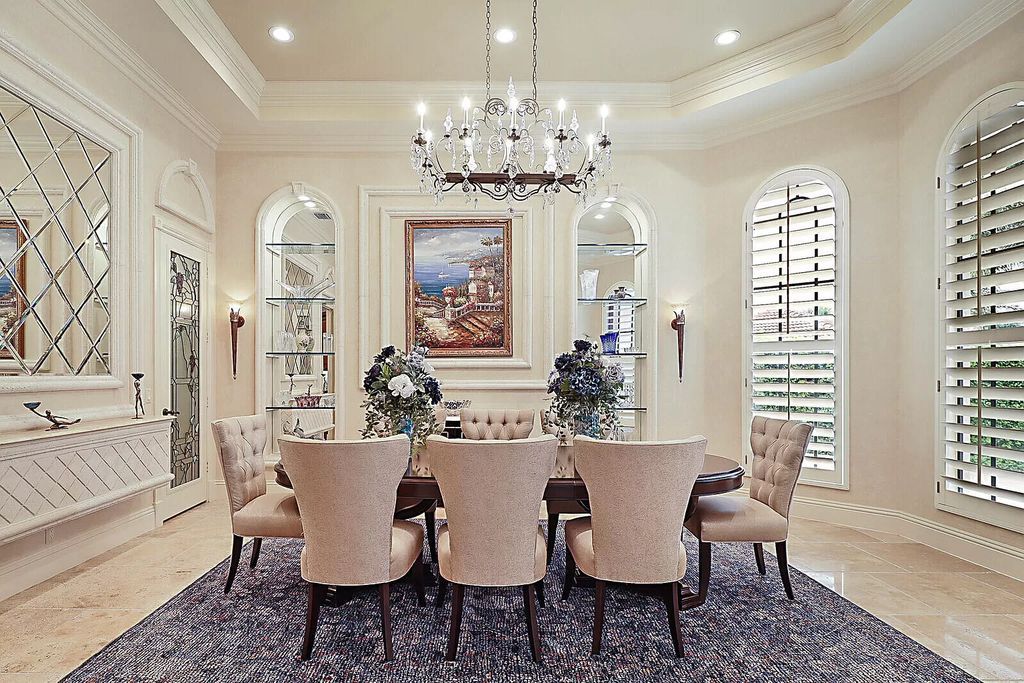 This dream home features a home office, theater, chef's kitchen with high-end appliances, dual-zone wine refrigerators, and lavish architectural details.