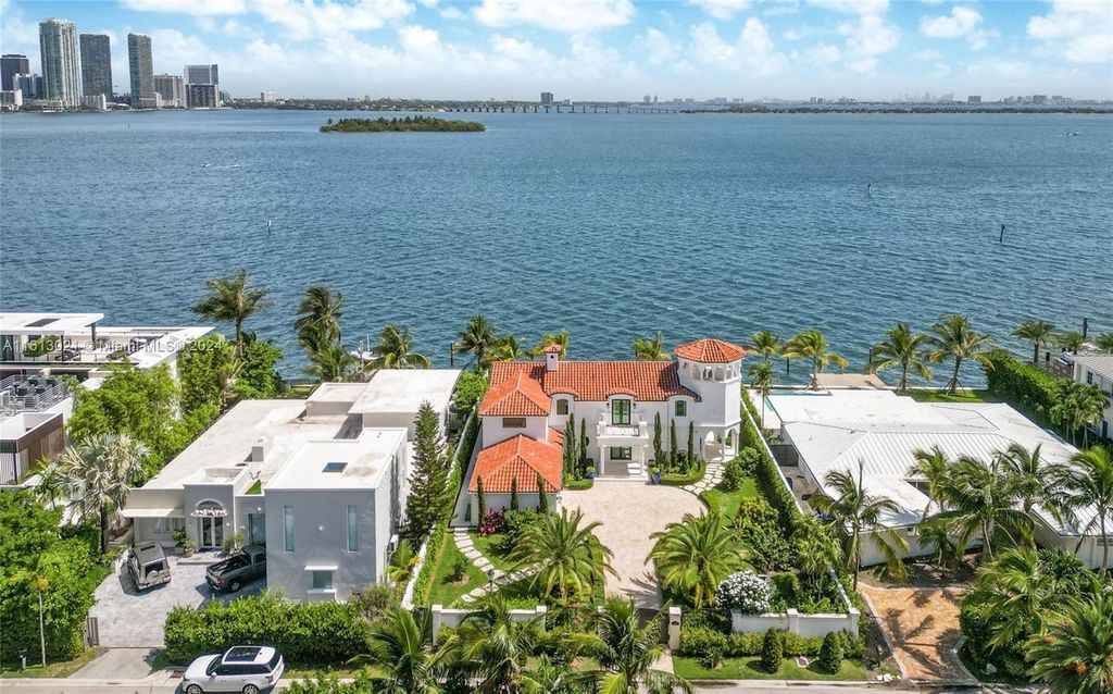 Completely remodeled in 2023, this estate boasts 3,808 SF of modern sophistication and timeless charm. Enjoy unobstructed bay views of Miami Beach, Downtown, and Brickell from the 12,750 square feet lot with 85 feet of bay frontage, perfect for a large boat.