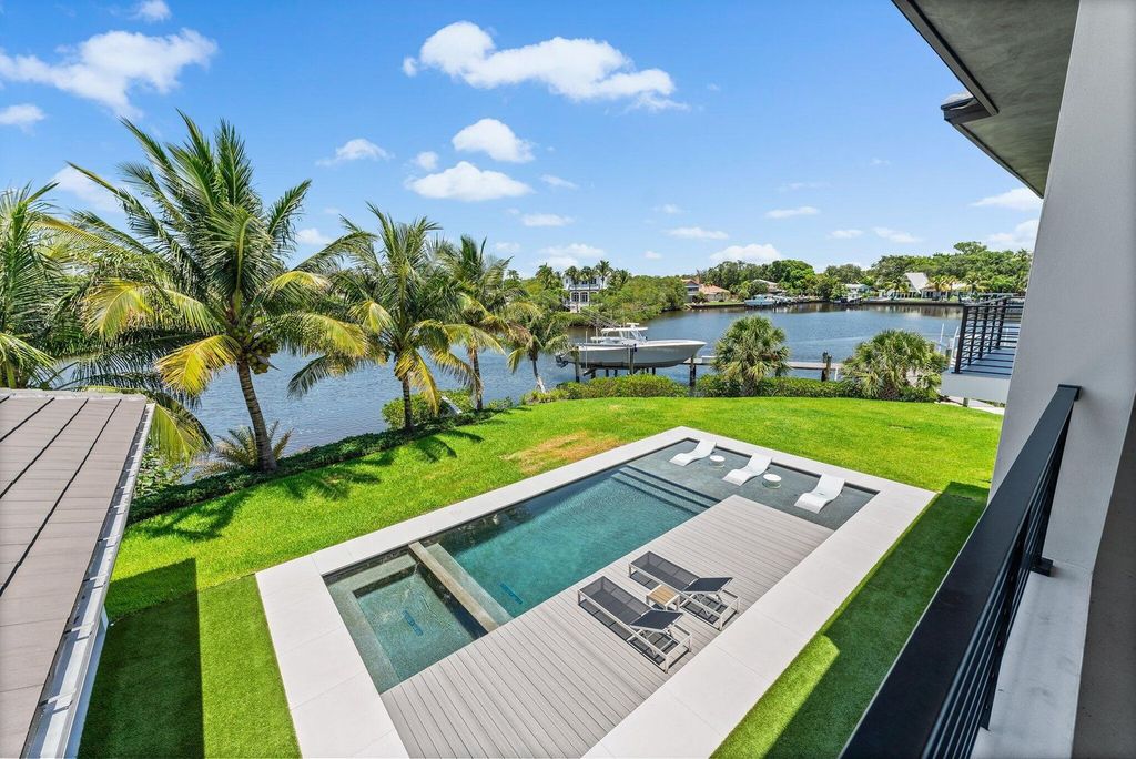 Discover unparalleled luxury in this one-of-a-kind waterfront estate at 18941 SE Reach Island Ln, Jupiter, Florida, nestled in the exclusive, gated community of the Islands of Jupiter.