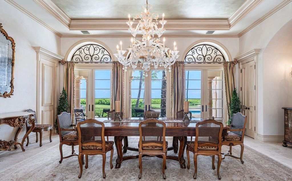 This 12,627 square feet Mediterranean estate, constructed in 2000, features 8 bedrooms and 10 bathrooms, including 2 private guest wings with kitchenettes and stunning ocean views.