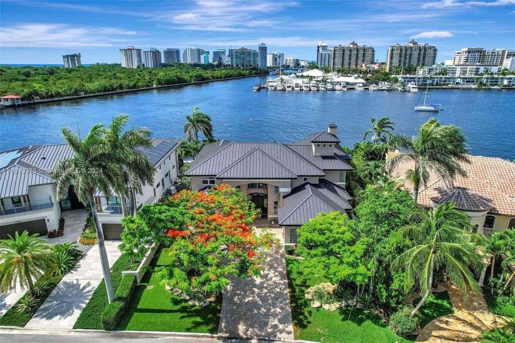 A boater's dream, the estate sits on a 12,651 square feet lot with a 2,000 square feet dock and boat lift. The 6,788 square feet home features generous living areas, an elevator, and an expansive second-floor terrace with an oversized primary bedroom, loft, and office den.