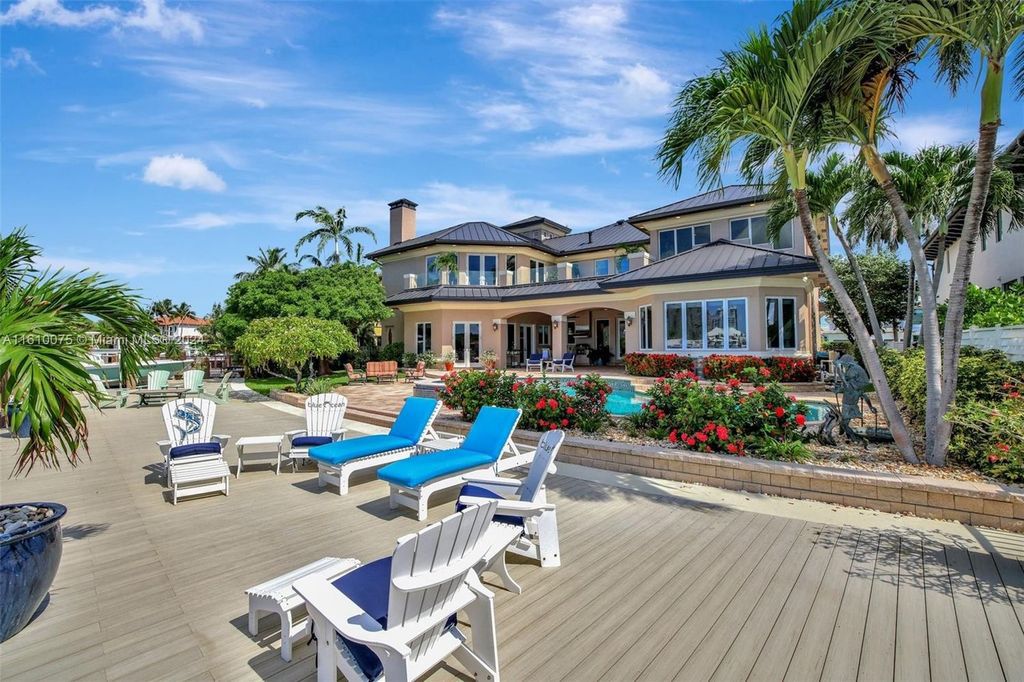 A boater's dream, the estate sits on a 12,651 square feet lot with a 2,000 square feet dock and boat lift. The 6,788 square feet home features generous living areas, an elevator, and an expansive second-floor terrace with an oversized primary bedroom, loft, and office den.