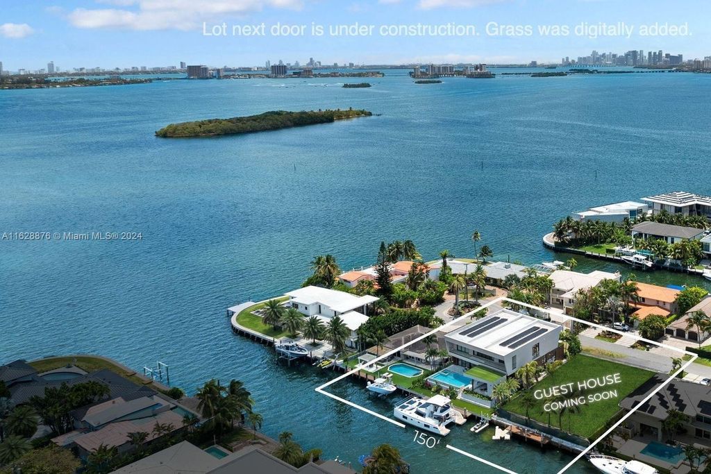 Discover an extraordinary waterfront compound in gated San Souci Estates, featuring a brand new ultra-modern home and a sophisticated guest house on a double lot.