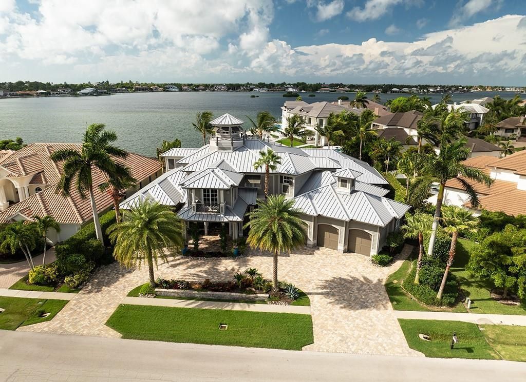 This stunning 7,105 square foot South Florida home, built in 2014 and never before on the market, epitomizes luxury living. Located at 1611 Collingswood Ct, Marco Island, FL 34145, it features 4 bedrooms, 7 bathrooms, a 3-story foyer, office, wine room, and an open concept kitchen.