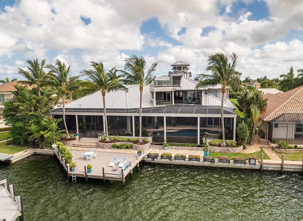 This stunning 7,105 square foot South Florida home, built in 2014 and never before on the market, epitomizes luxury living. Located at 1611 Collingswood Ct, Marco Island, FL 34145, it features 4 bedrooms, 7 bathrooms, a 3-story foyer, office, wine room, and an open concept kitchen.