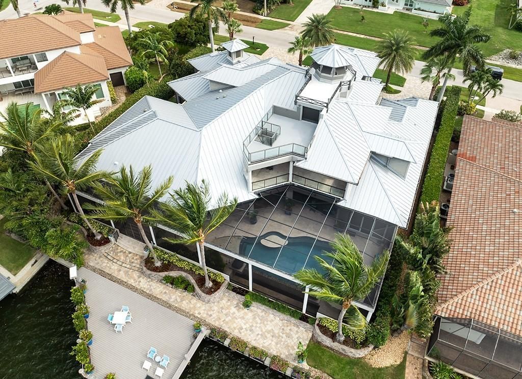 This stunning 7,105 square foot South Florida home, built in 2014 and never before on the market, epitomizes luxury living. Located at 1611 Collingswood Ct, Marco Island, FL 34145, it features 4 bedrooms, 7 bathrooms, a 3-story foyer, office, wine room, and an open concept kitchen.