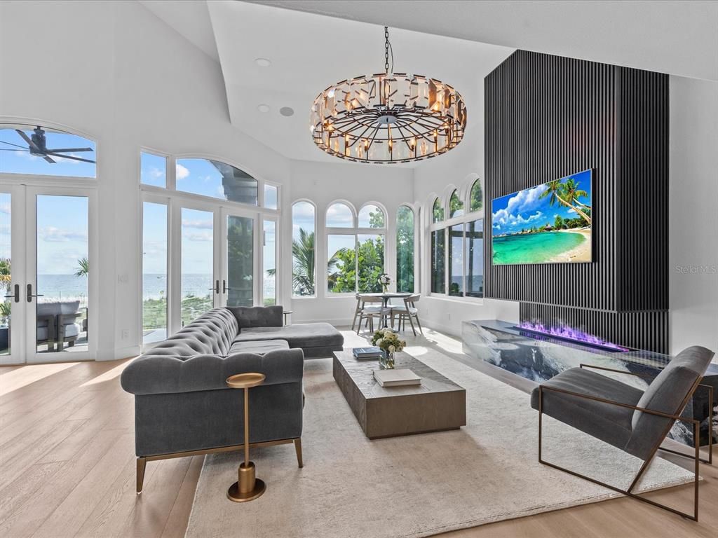 Enjoy modern elegance with breathtaking ocean views, a gourmet kitchen with marble countertops, a state-of-the-art water vapor fireplace, and over 10 TVs.