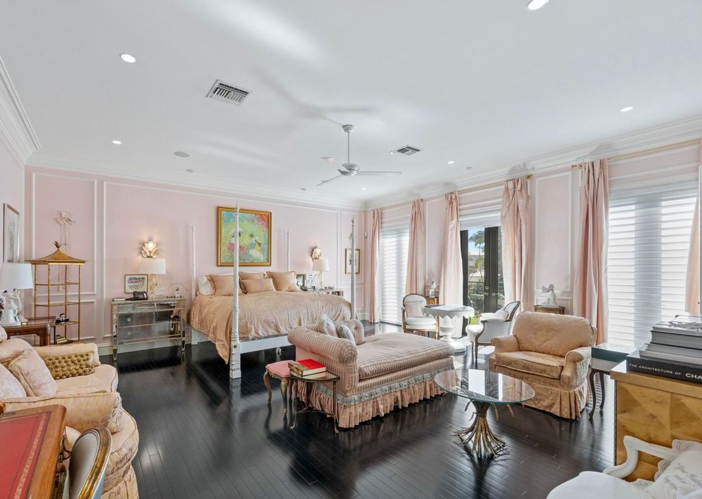 This 6-bedroom, 6.5-bathroom masterpiece, inspired by classic European estates, boasts soaring ceilings, a sweeping staircase, and grand living spaces including formal living and dining rooms, a den, and a separate bar.