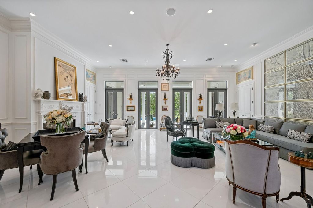 This 6-bedroom, 6.5-bathroom masterpiece, inspired by classic European estates, boasts soaring ceilings, a sweeping staircase, and grand living spaces including formal living and dining rooms, a den, and a separate bar.