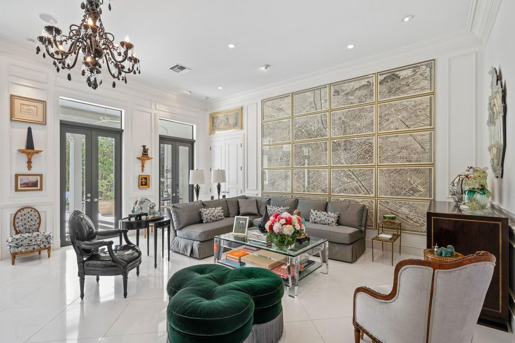 This 6-bedroom, 6.5-bathroom masterpiece, inspired by classic European estates, boasts soaring ceilings, a sweeping staircase, and grand living spaces including formal living and dining rooms, a den, and a separate bar.