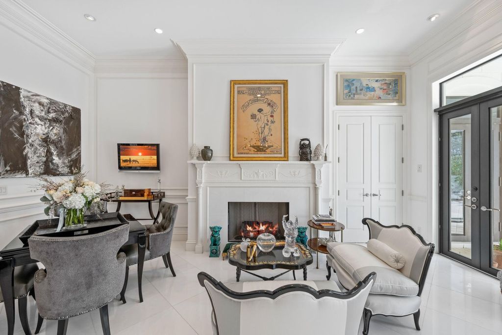 This 6-bedroom, 6.5-bathroom masterpiece, inspired by classic European estates, boasts soaring ceilings, a sweeping staircase, and grand living spaces including formal living and dining rooms, a den, and a separate bar.