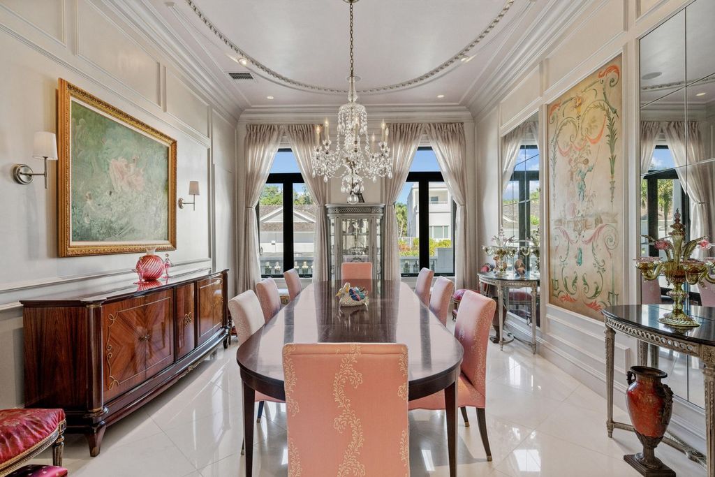 This 6-bedroom, 6.5-bathroom masterpiece, inspired by classic European estates, boasts soaring ceilings, a sweeping staircase, and grand living spaces including formal living and dining rooms, a den, and a separate bar.