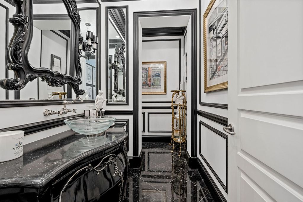 This 6-bedroom, 6.5-bathroom masterpiece, inspired by classic European estates, boasts soaring ceilings, a sweeping staircase, and grand living spaces including formal living and dining rooms, a den, and a separate bar.