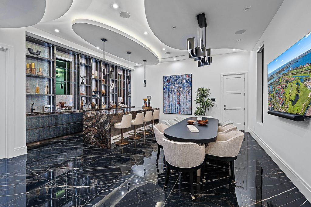 Discover the pinnacle of coastal luxury in this brand-new, open-concept transitional estate at 114 Quayside Dr, located within the prestigious Admirals Cove community in Jupiter, FL.