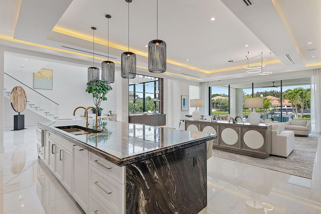 Discover the pinnacle of coastal luxury in this brand-new, open-concept transitional estate at 114 Quayside Dr, located within the prestigious Admirals Cove community in Jupiter, FL.