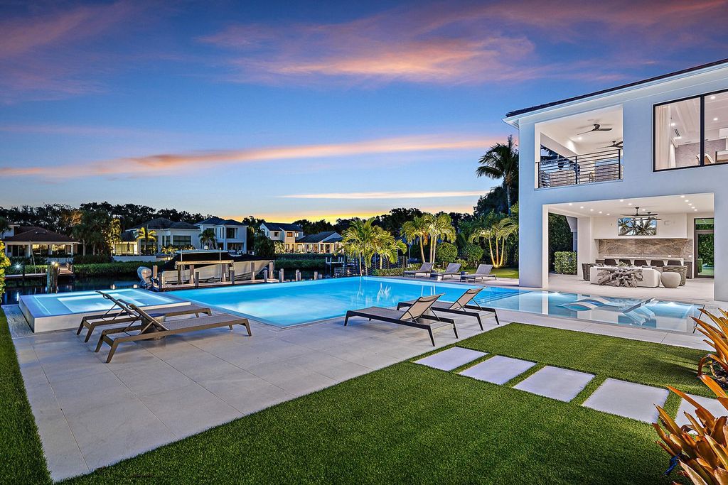 Discover the pinnacle of coastal luxury in this brand-new, open-concept transitional estate at 114 Quayside Dr, located within the prestigious Admirals Cove community in Jupiter, FL.