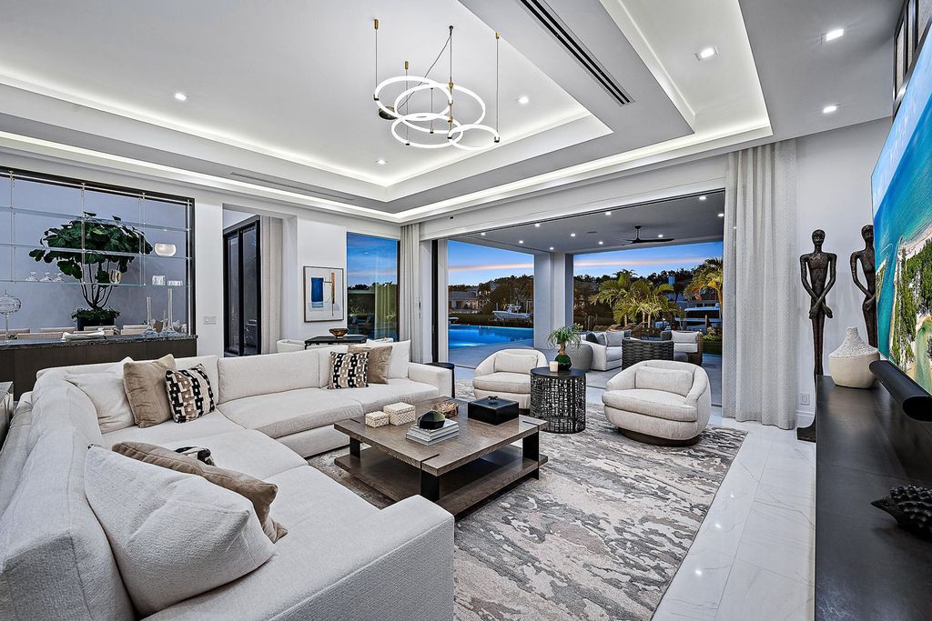 Discover the pinnacle of coastal luxury in this brand-new, open-concept transitional estate at 114 Quayside Dr, located within the prestigious Admirals Cove community in Jupiter, FL.