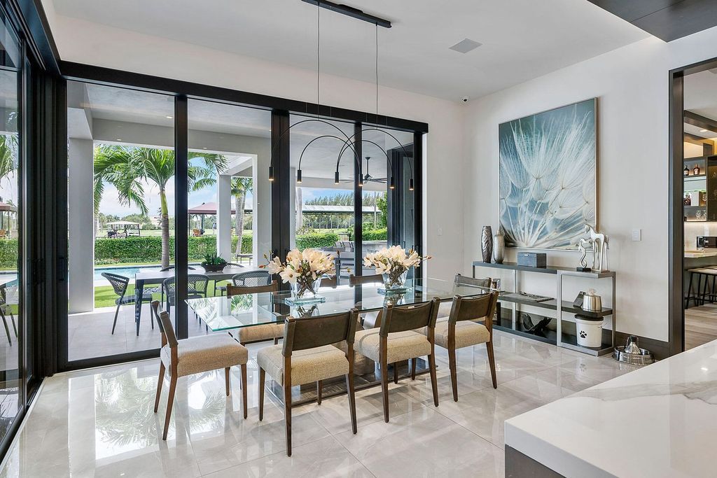 Offering 102 feet of prime golf course frontage, this contemporary 5-bedroom, 7-bath home boasts over 7,200 square feet of luxurious living space.