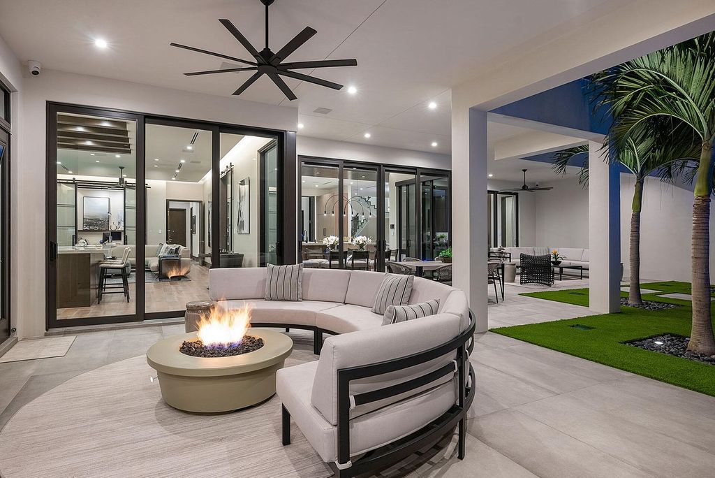 Offering 102 feet of prime golf course frontage, this contemporary 5-bedroom, 7-bath home boasts over 7,200 square feet of luxurious living space.