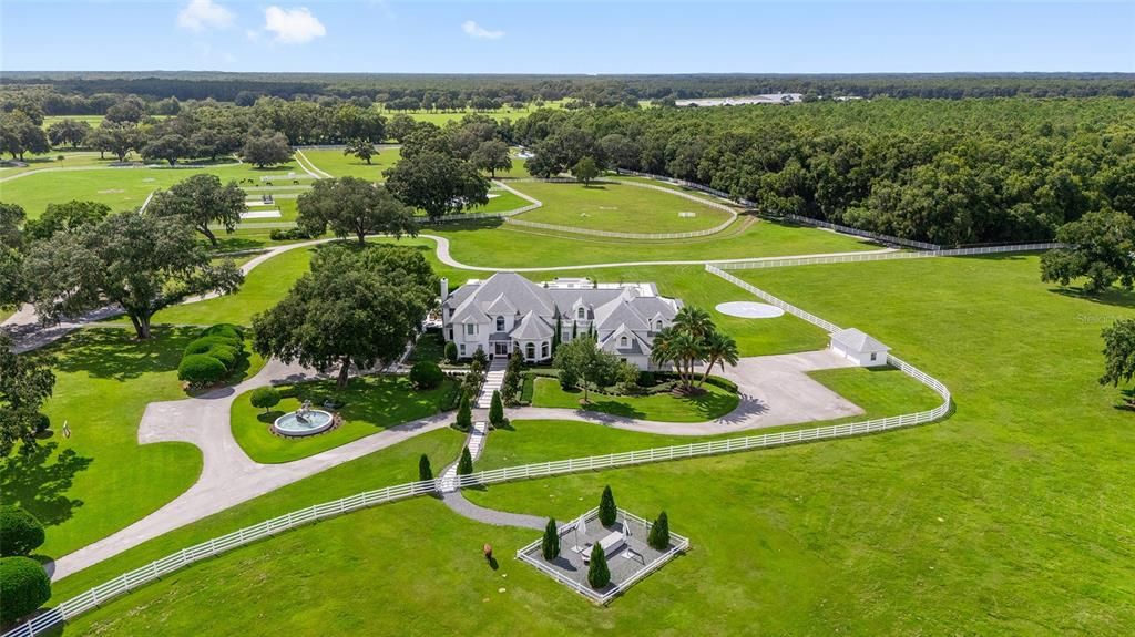 This 10,000 square feet main residence features 8 bedrooms, including separate caretaker's quarters, and boasts a grand foyer with 20-foot ceilings, a gourmet kitchen, and ample entertainment space.