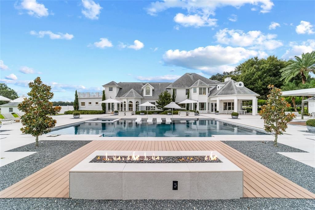 This 10,000 square feet main residence features 8 bedrooms, including separate caretaker's quarters, and boasts a grand foyer with 20-foot ceilings, a gourmet kitchen, and ample entertainment space.