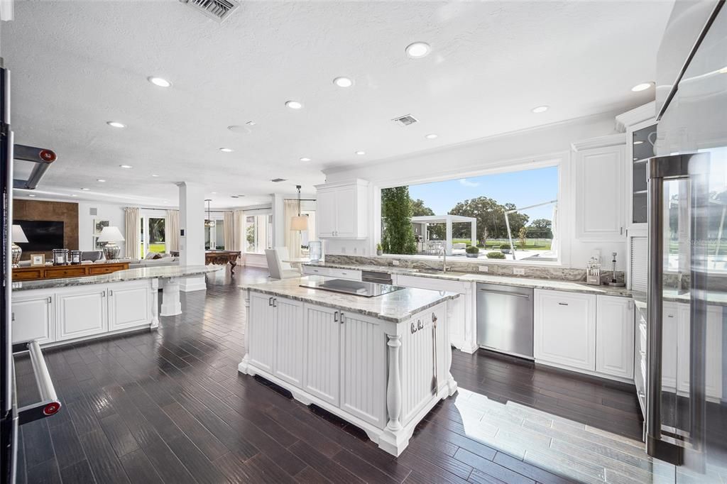 This 10,000 square feet main residence features 8 bedrooms, including separate caretaker's quarters, and boasts a grand foyer with 20-foot ceilings, a gourmet kitchen, and ample entertainment space.