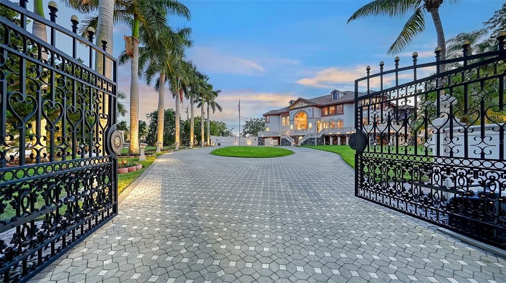 Featuring imported marble floors, Venetian plaster walls, and gold leaf moldings, the residence exudes Old World elegance. Enjoy breathtaking sunsets from terraces, gardens, or the Versace-inspired pool area.