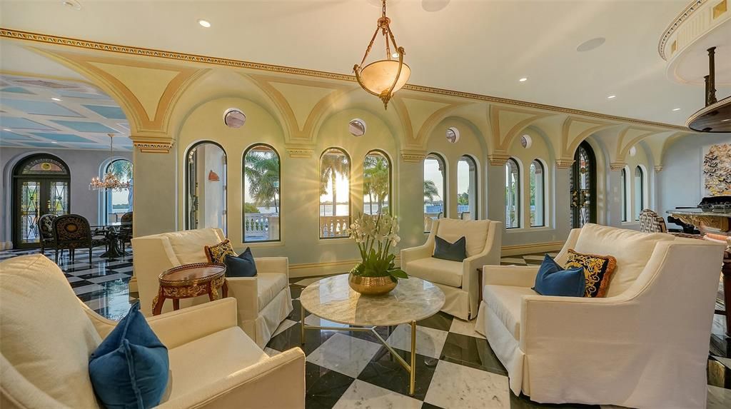 Featuring imported marble floors, Venetian plaster walls, and gold leaf moldings, the residence exudes Old World elegance. Enjoy breathtaking sunsets from terraces, gardens, or the Versace-inspired pool area.