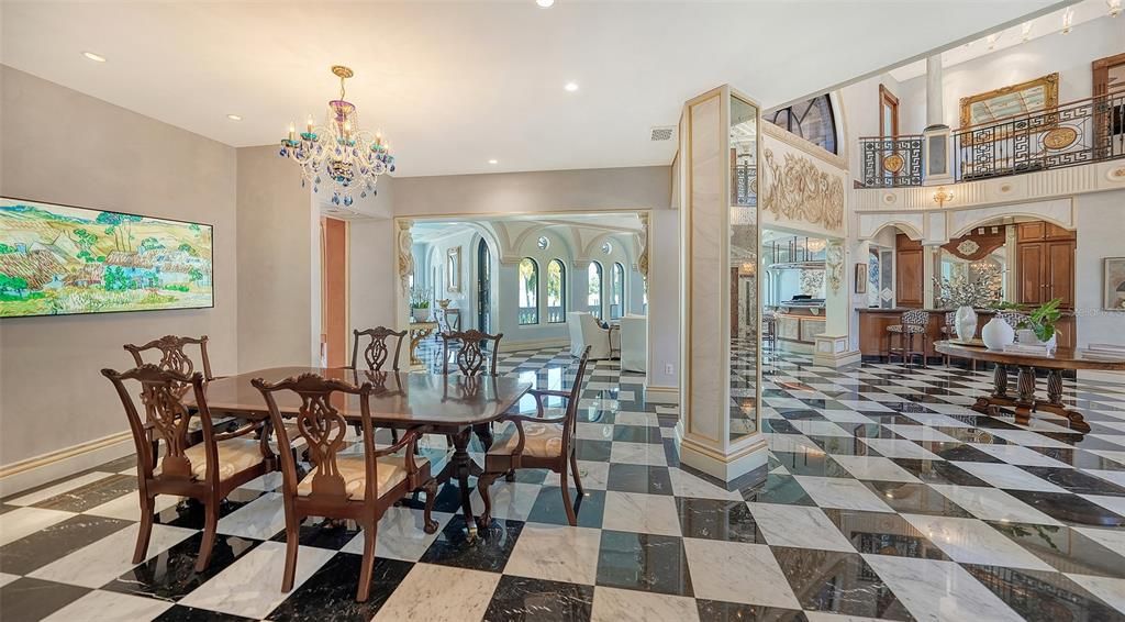 Featuring imported marble floors, Venetian plaster walls, and gold leaf moldings, the residence exudes Old World elegance. Enjoy breathtaking sunsets from terraces, gardens, or the Versace-inspired pool area.