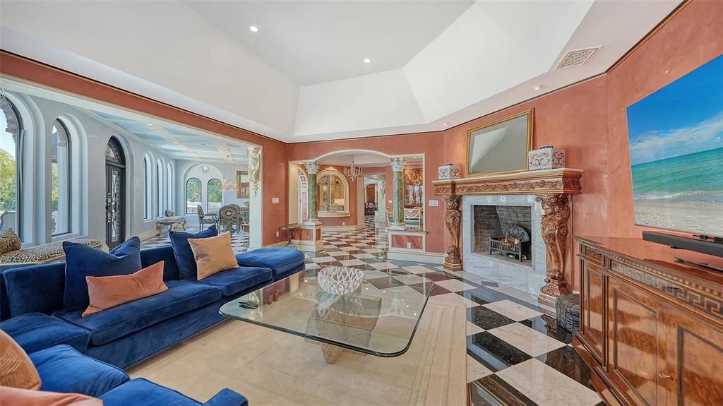 Featuring imported marble floors, Venetian plaster walls, and gold leaf moldings, the residence exudes Old World elegance. Enjoy breathtaking sunsets from terraces, gardens, or the Versace-inspired pool area.