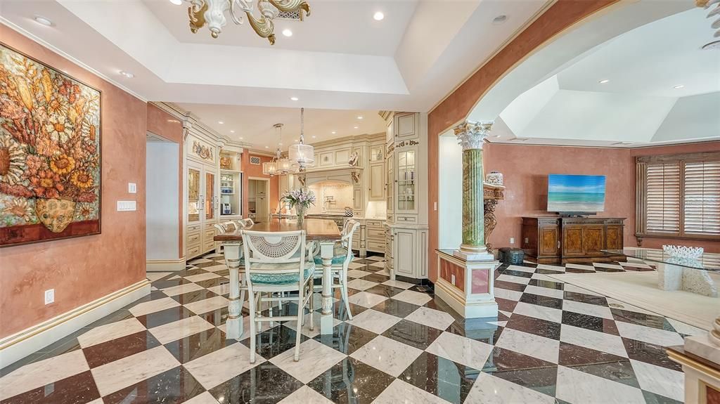 Featuring imported marble floors, Venetian plaster walls, and gold leaf moldings, the residence exudes Old World elegance. Enjoy breathtaking sunsets from terraces, gardens, or the Versace-inspired pool area.