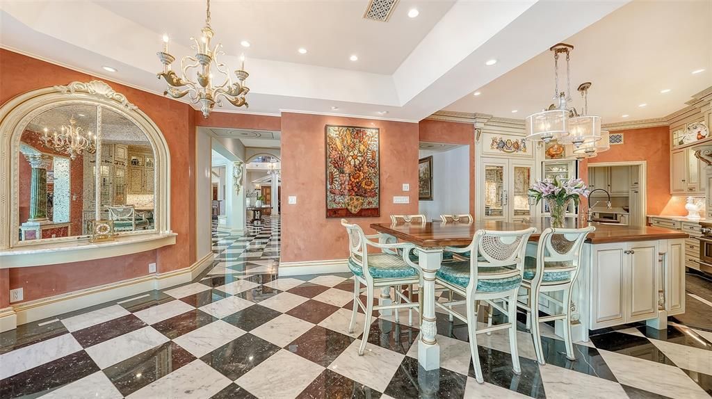 Featuring imported marble floors, Venetian plaster walls, and gold leaf moldings, the residence exudes Old World elegance. Enjoy breathtaking sunsets from terraces, gardens, or the Versace-inspired pool area.