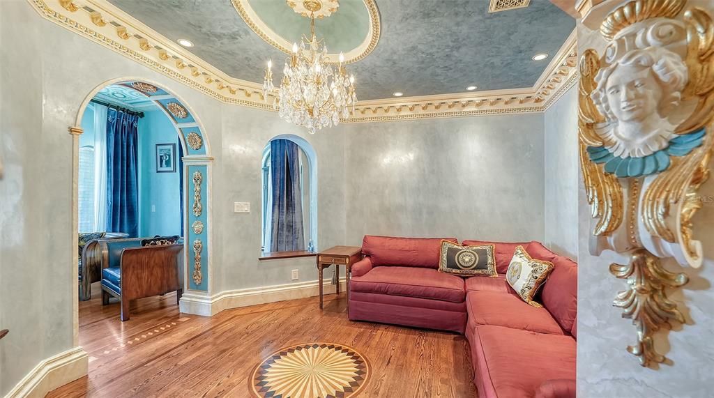 Featuring imported marble floors, Venetian plaster walls, and gold leaf moldings, the residence exudes Old World elegance. Enjoy breathtaking sunsets from terraces, gardens, or the Versace-inspired pool area.